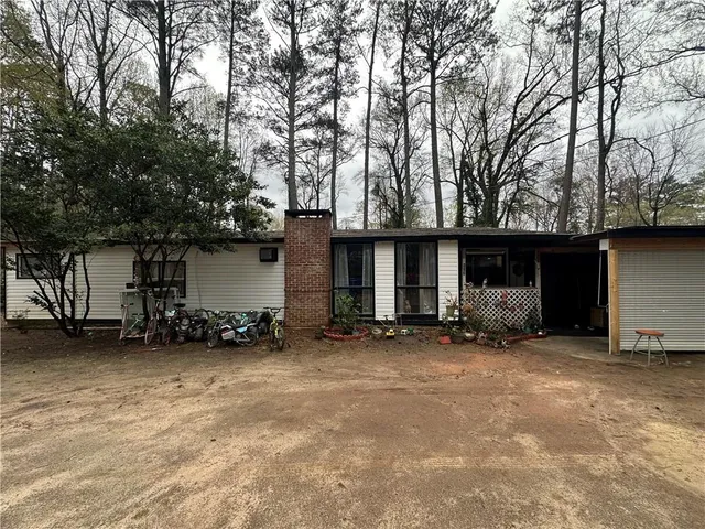 a big house with trees in front of it