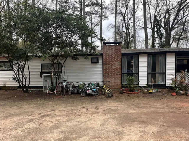 a view of a house with a yard and sitting area