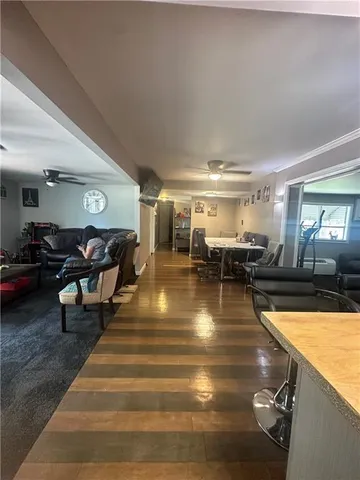 a living room with lots of chairs and a table