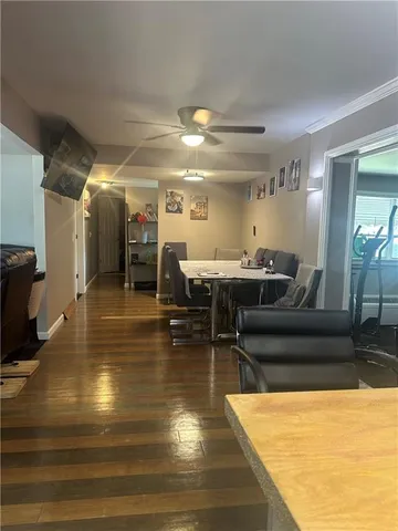 a living room with furniture and a view of kitchen