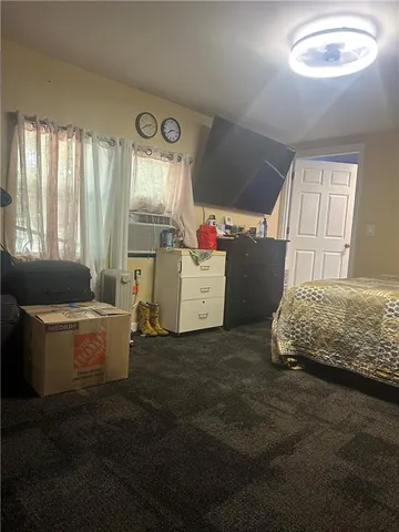 a bed sitting in a bedroom next to a window