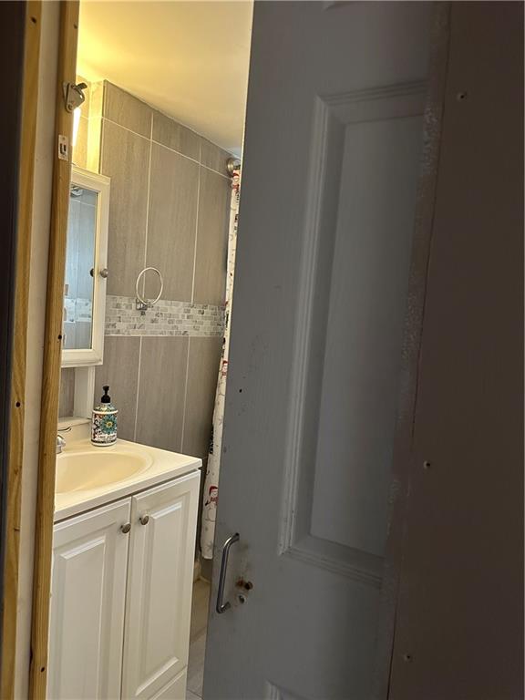 123 Spring Street Stockbridge, GA 30281 - Photo 29 of 47 a bathroom with a sink a toilet a mirror and vanity