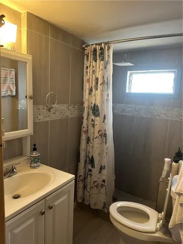 a kitchen with a refrigerator wooden floor and cabinets