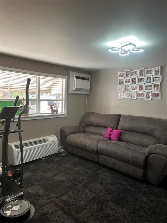123 Spring Street Stockbridge, GA 30281 - Photo 37 of 47 a living room with furniture a window and a flat screen tv
