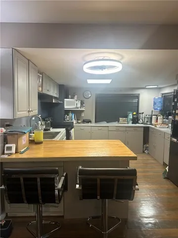 a room with table chairs and appliances