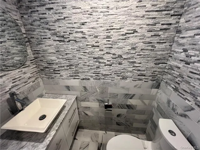 a bathroom with a sink a toilet and a shower