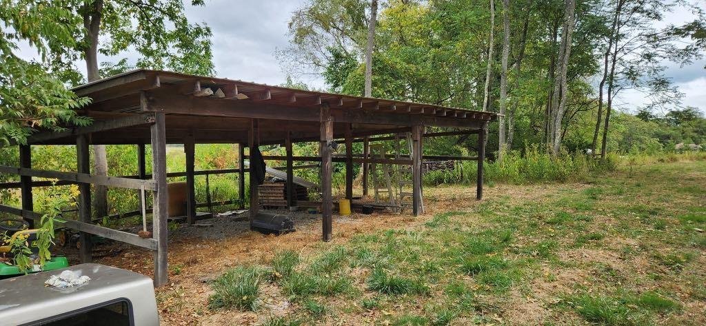 118 Tomcat Hollow Road Point Marion, PA 15474 - Photo 2 of 30 a backyard of a house with table and chairs under an umbrella