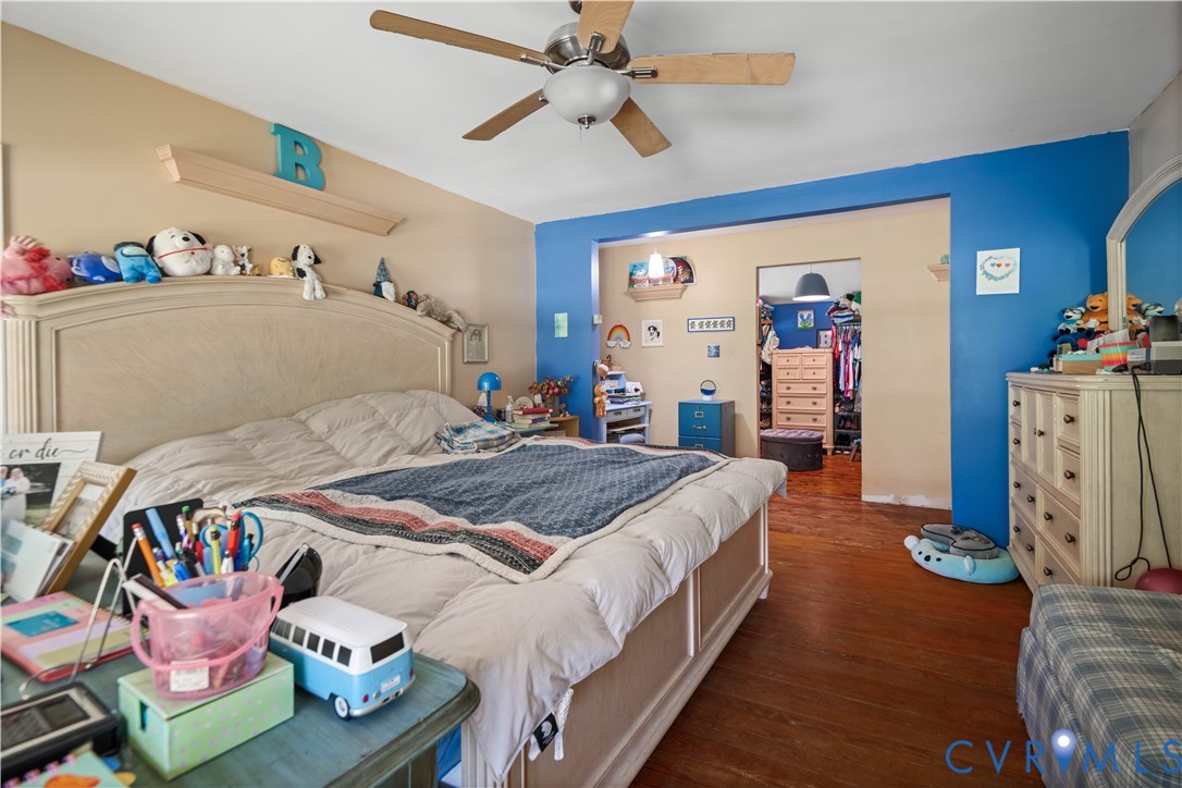 6243 Studley Road Mechanicsville, VA 23116 - Photo 37 of 65 a bedroom with bed and a chandelier