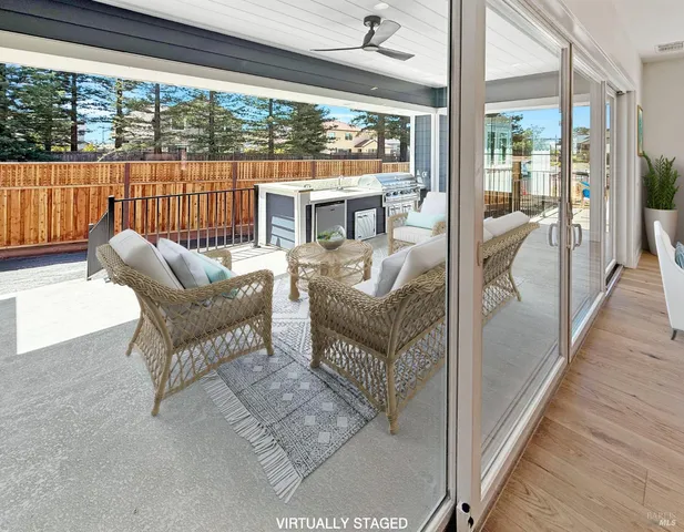 a balcony with furniture and a large window
