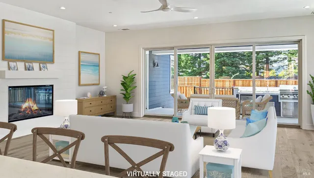 a living room with fireplace furniture and a large window