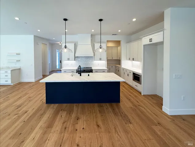 a room with a bed wooden floor and window