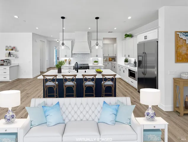 a living room with furniture kitchen and a chandelier