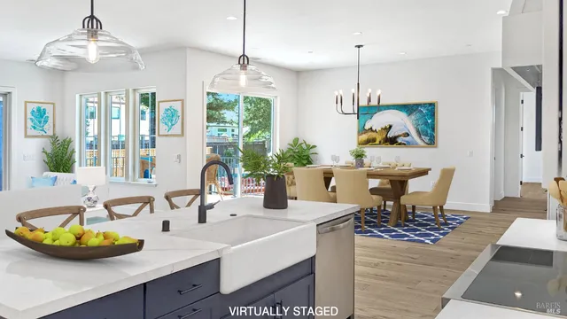 a dining room with furniture a chandelier and wooden floor