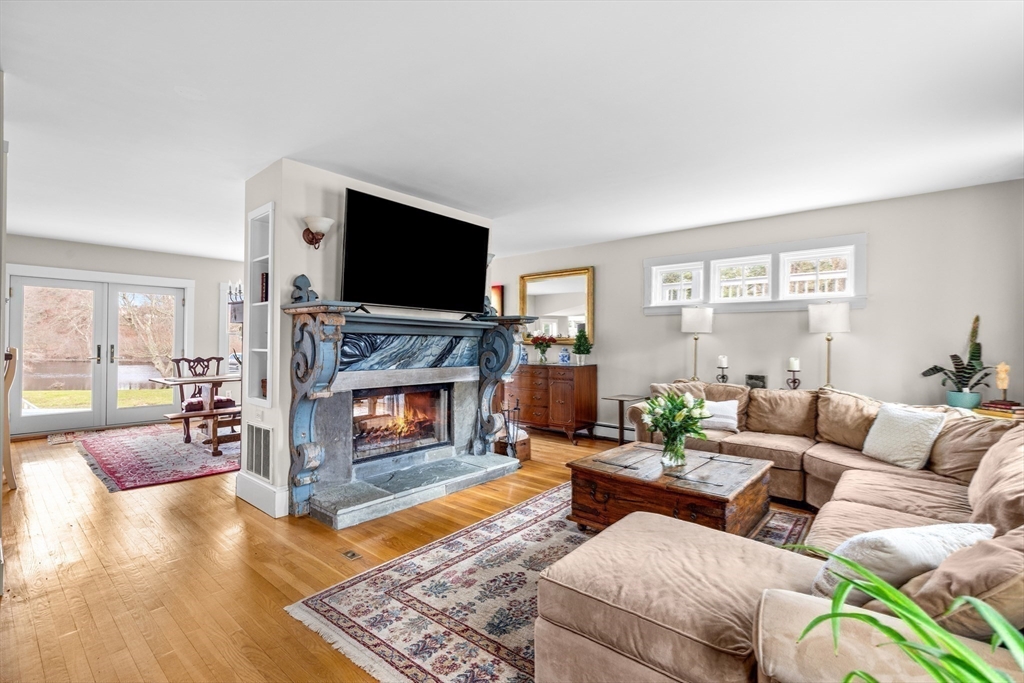 30 South River Street Wellesley, MA 02482 - Photo 16 of 29 a living room with furniture a flat screen tv and a fireplace