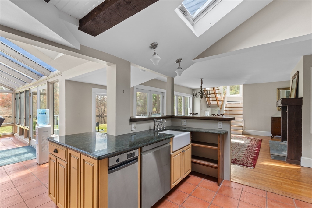 30 South River Street Wellesley, MA 02482 - Photo 7 of 29 a kitchen with granite countertop a sink cabinets and stainless steel appliances