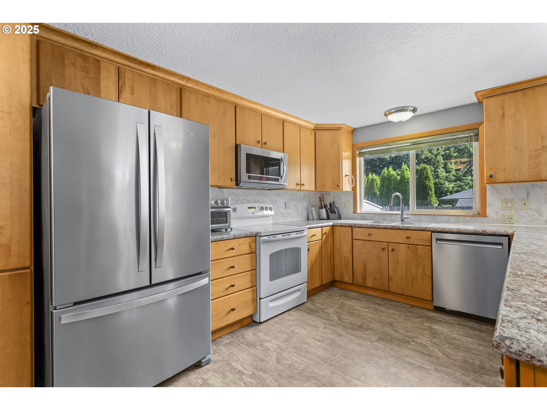 9630 Southwest Robbins Drive Beaverton, OR 97008 - Photo 12 of 35 a kitchen with a refrigerator sink and microwave