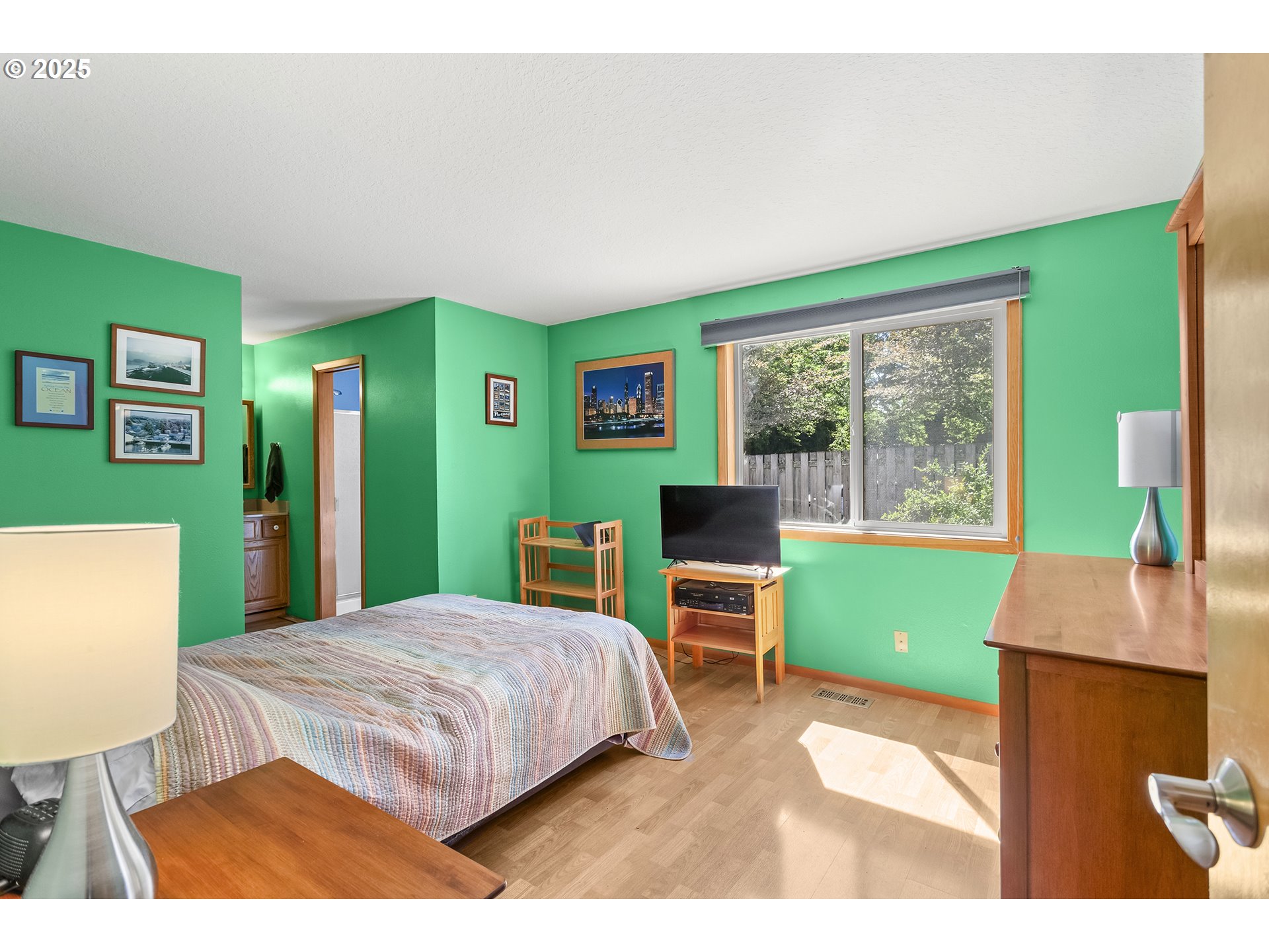 9630 Southwest Robbins Drive Beaverton, OR 97008 - Photo 18 of 35 a bedroom with a bed a table and a window