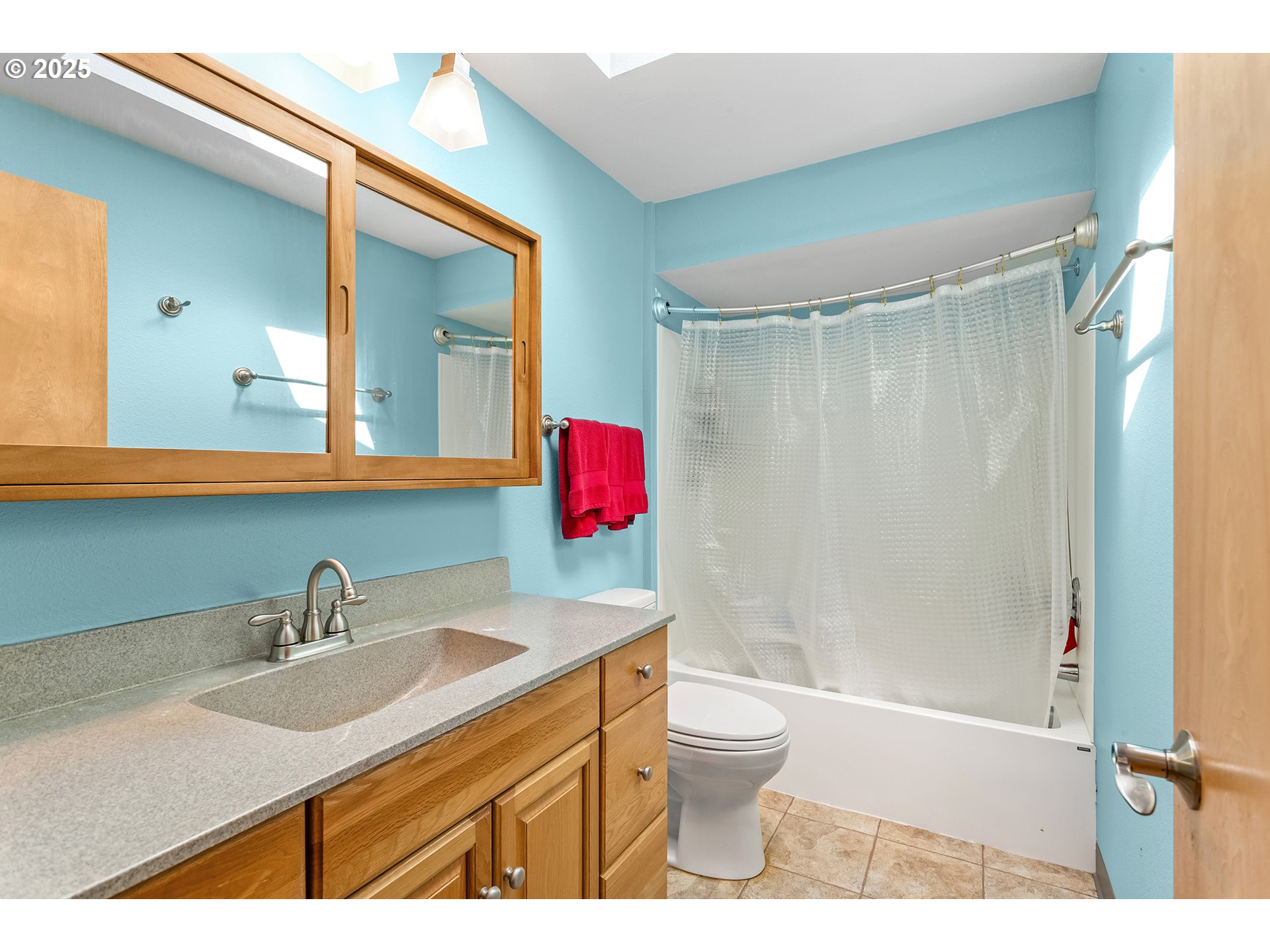 9630 Southwest Robbins Drive Beaverton, OR 97008 - Photo 19 of 35 a bathroom with a sink toilet a mirror and shower