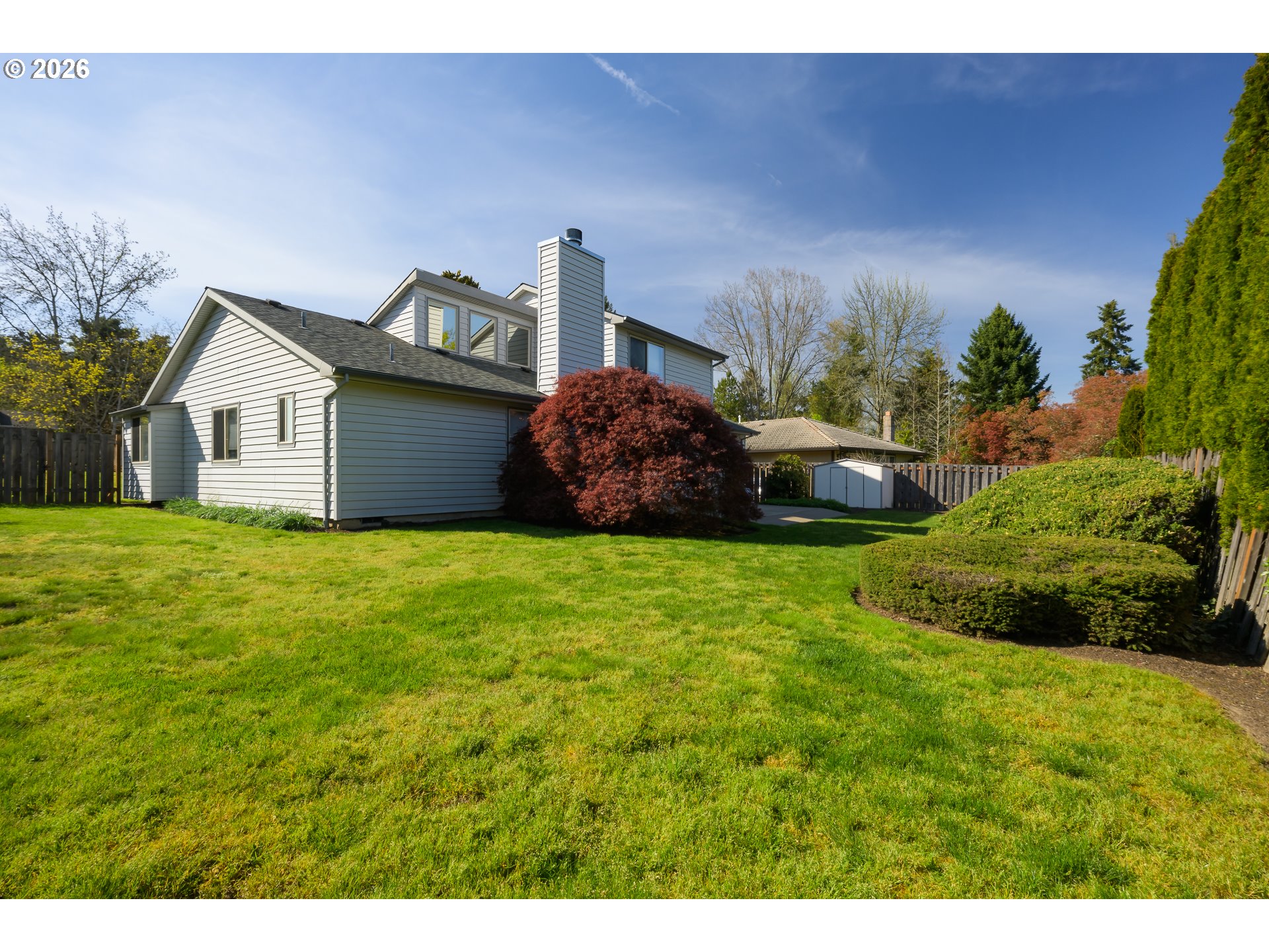 9630 Southwest Robbins Drive Beaverton, OR 97008 - Photo 31 of 35 a front view of a house with a garden and yard