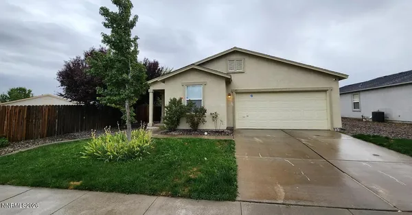 a front view of house with a garden