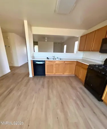 a view of a kitchen with a sink and cabinets