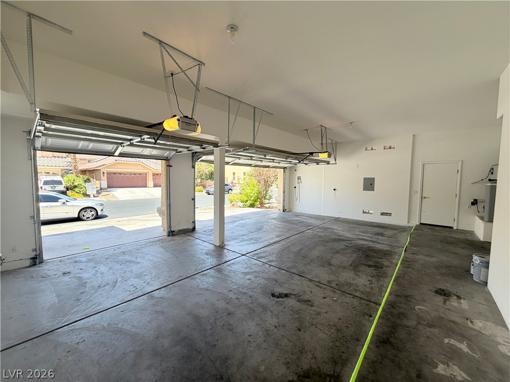 6116 Rabbit Track Street Las Vegas, NV 89130 - Photo 25 of 28 Ample garage space with two automatic doors offers secure parking and convenient access.