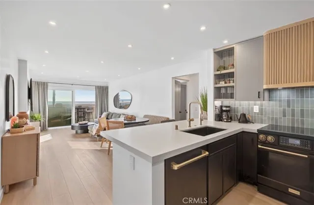 a kitchen with sink a stove and cabinets