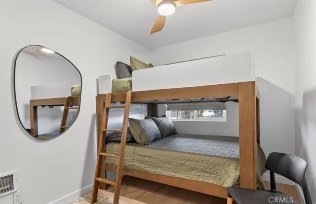 a view of a kitchen with a sink and dishwasher with wooden floor
