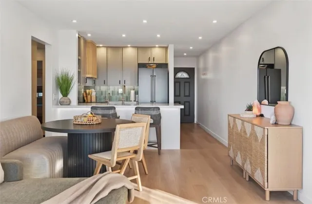 a living room with a flat screen tv and potted plant