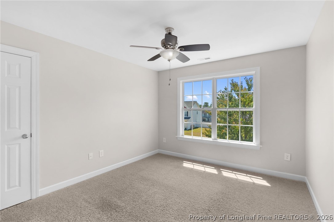 50 Huzzas Circle Cameron, NC 28326 - Photo 23 of 39 an empty room with windows and fan