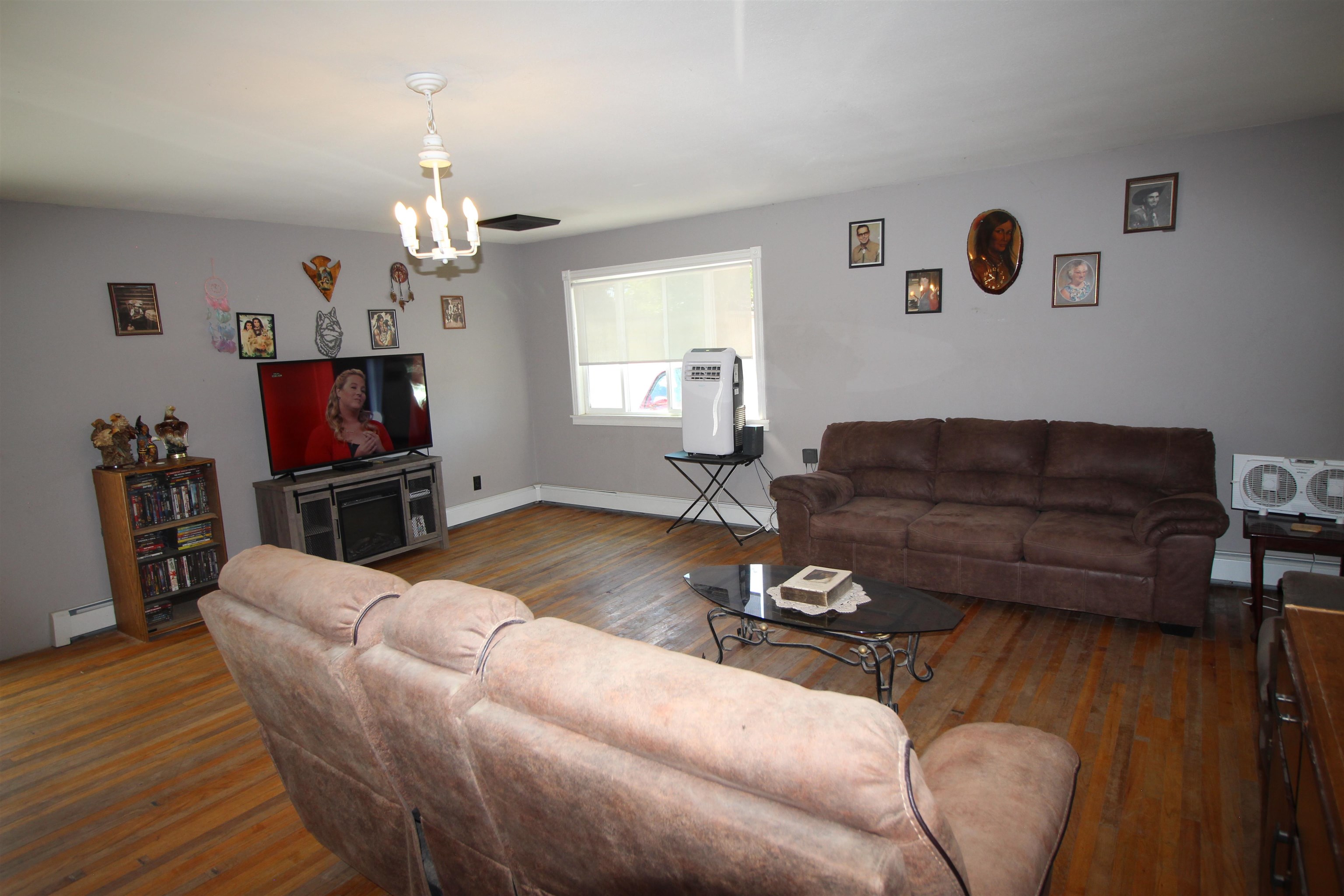 1150 East 7th Street Delta, CO 81416 - Photo 13 of 32 a living room with furniture a flat screen tv and wooden floor