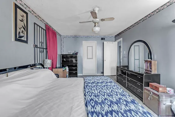 a bedroom with a bed dresser and a large mirror