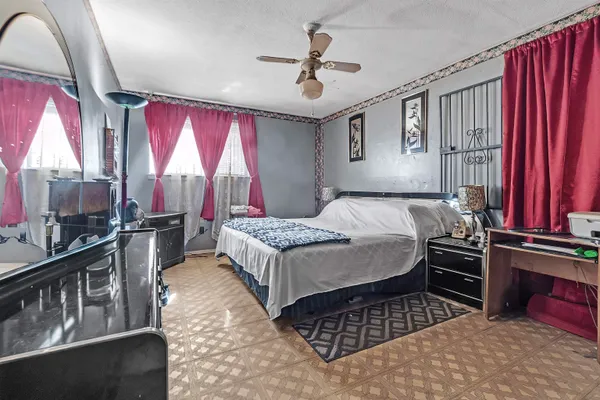 a bedroom with a bed next to a window