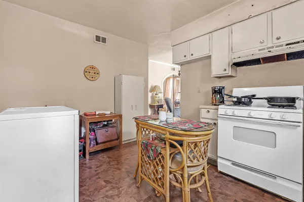 a kitchen with stainless steel appliances a stove a refrigerator and a refrigerator