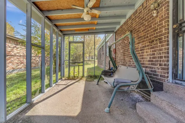 a view of a patio with a table chairs and wooden fence