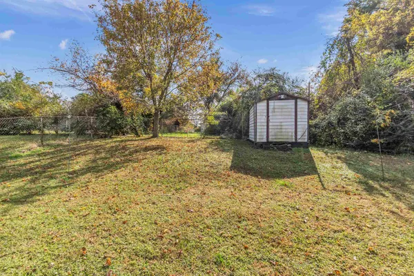 a view of a backyard with large trees