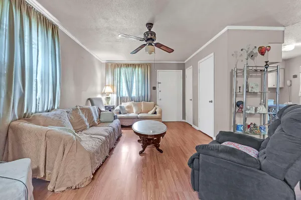 a living room with furniture and a chandelier