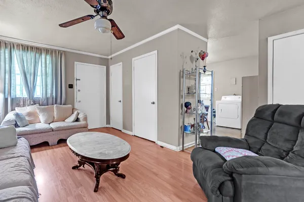 a living room with furniture and wooden floor