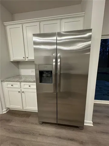 a kitchen with kitchen island granite countertop a sink cabinets and stainless steel appliances