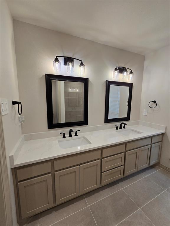 3601 Scott Drive Rowlett, TX 75088 - Photo 11 of 19 a bathroom with double sink and a mirror