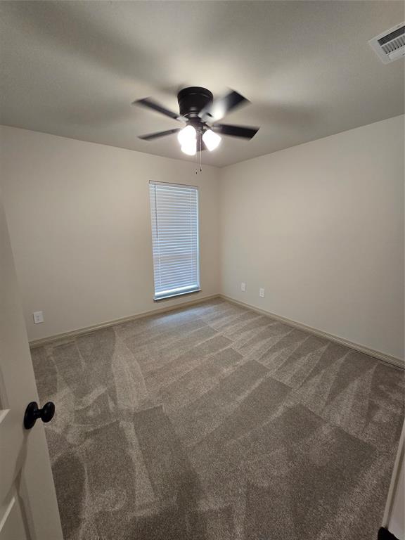 3601 Scott Drive Rowlett, TX 75088 - Photo 17 of 19 a view of an empty room with a chandelier fan