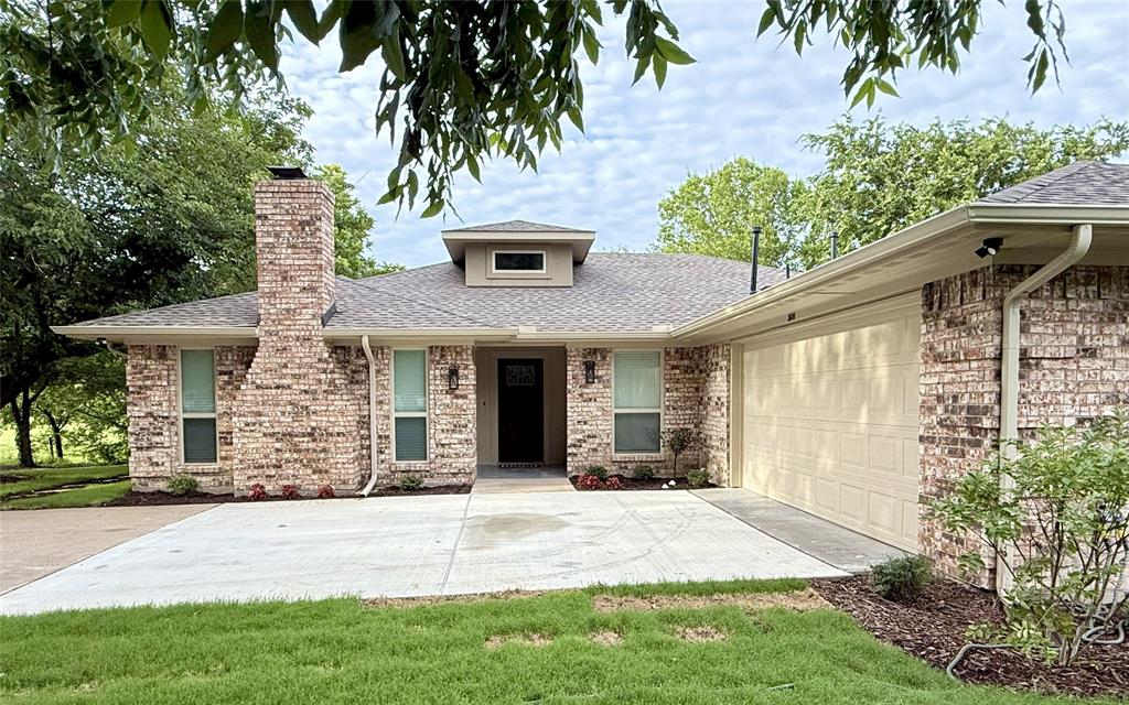 3601 Scott Drive Rowlett, TX 75088 - Photo 2 of 19 a front view of a house with a garden