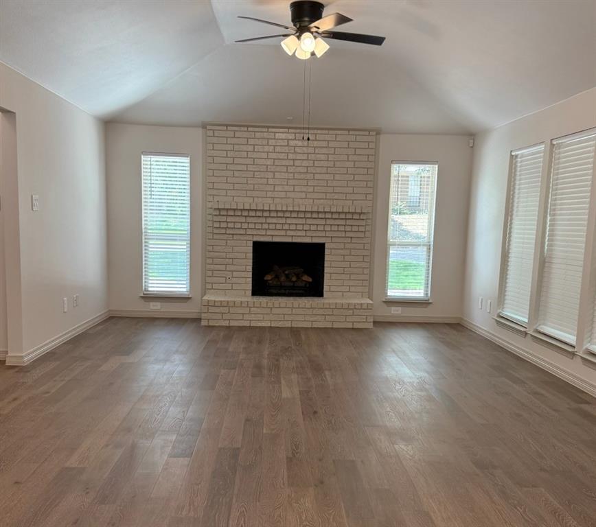 3601 Scott Drive Rowlett, TX 75088 - Photo 4 of 19 an empty room with windows fireplace and wooden floor