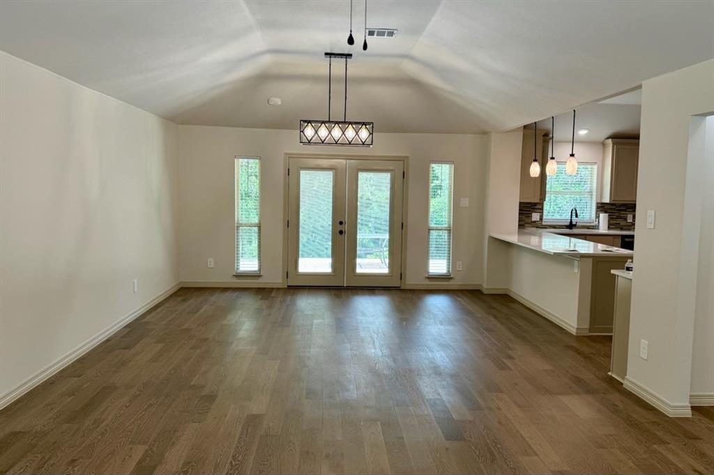 3601 Scott Drive Rowlett, TX 75088 - Photo 5 of 19 an empty room with wooden floor and windows