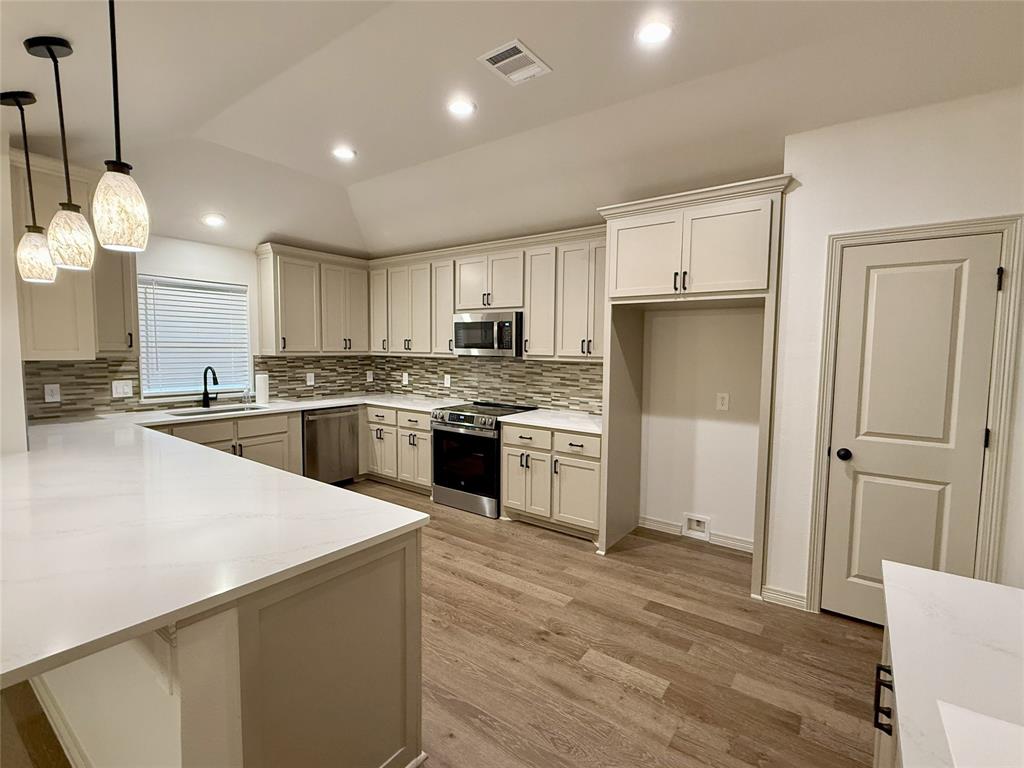 3601 Scott Drive Rowlett, TX 75088 - Photo 6 of 19 a kitchen with stainless steel appliances granite countertop a sink a stove a refrigerator and island with wooden floor