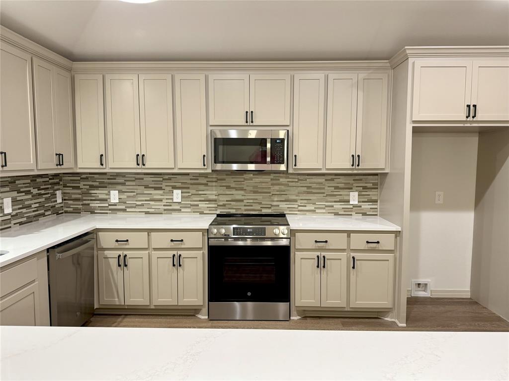 3601 Scott Drive Rowlett, TX 75088 - Photo 8 of 19 a kitchen with a stove sink and cabinets