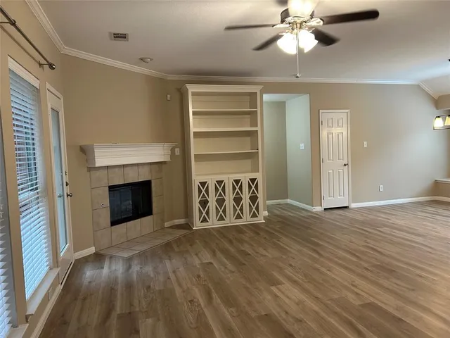 a view of an empty room with a fireplace and a window