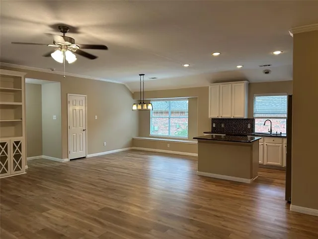 a view of a kitchen with a sink cabinets and wooden floor