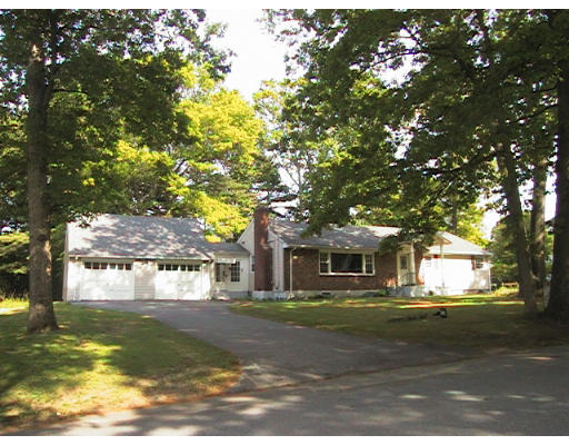 31 Sylvan Road Lancaster, MA 01523 - Photo 1 of 2 a front view of a house with a yard garage and large trees