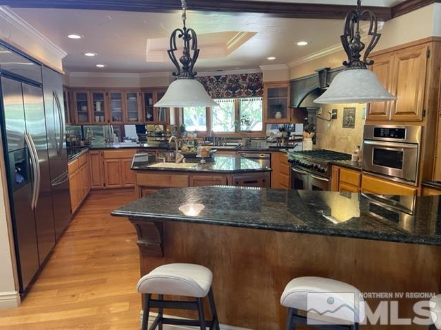 2464 East Lakeridge Reno, NV 89519 - Photo 4 of 10 a kitchen with stainless steel appliances granite countertop a sink a stove and a wooden cabinets